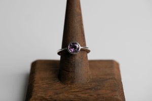 Sterling silver 7mm round faceted amethyst bezel set solitaire ring by Brian Bibeau Designs.