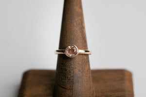 14k yellow gold 6mm round faceted Oregon sunstone bezel set solitaire ring by Brian Bibeau Designs. 