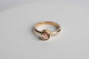 14k yellow gold 6mm round faceted Oregon sunstone bezel set solitaire ring by Brian Bibeau Designs. 