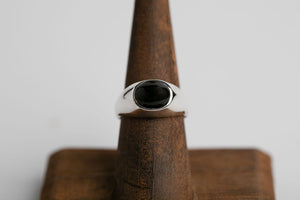 Sterling silver 10mm x 8mm oval cabochon Oregon black agate bezel set signet ring by Brian Bibeau Designs.