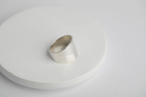 Sterling silver cigar wide band ring with a smooth, polished finish by Brian Bibeau Designs.