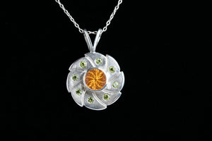 Sterling silver 10mm round vortex cut citrine bezel set pendant flanked with 8 green peridot by Brian Bibeau Designs.