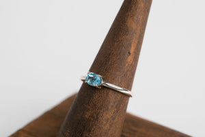 Swiss Blue Oval Stacker: Sterling silver 4x6 oval faceted swiss blue topaz 4 prong set ring by Brain Bibeau Designs.