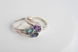 Oval Stacker Set: Sterling silver 4x6 oval faceted iolite, swiss blue and amethyst gemstones 4 prong set rings by Brian Bibeau Designs.